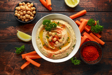 Hummus with olive oil, paprika, lemon and carrot.