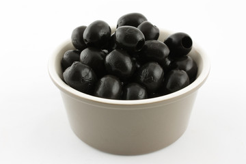 black olives in a bowl isolated on white background