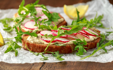 Hummus sourdough toast with reddish and wild rocket. Healthy vegan food