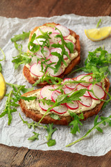 Hummus sourdough toast with reddish and wild rocket. Healthy vegan food