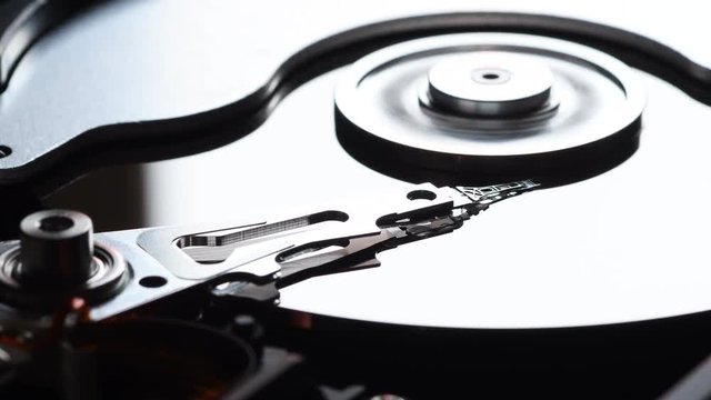 Detail of computer hard disk drive spin up and head movement. Shot in 4K UHD