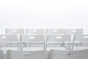 A row of white chairs in the lecture room white white background