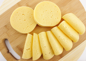 slices of cheese on a wooden board