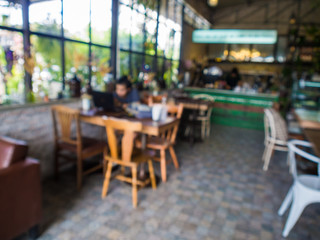 Fototapeta na wymiar Blurred indoor coffee shop with busy people