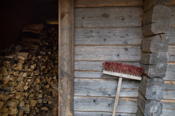 Brush leaning on the rustic cabin porch representing the balance between working and resting