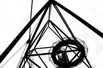 Incredible structure of the Tetrahedron in Bottrop, Germany captured on black and white picture taken from below in different perspective. The popular local landmark serves as a view point
