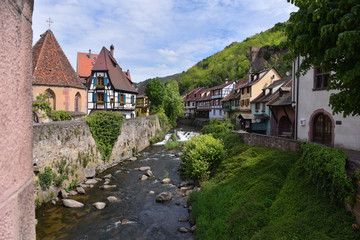 Houses next to La Weiss river in Kayserberg village in Alsace, France