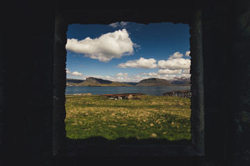 view of the window like a magical painting right into midst of the georges icelandic countryside on a sunny afternoon