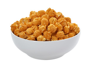 Gourmet cheddar popcorn in large porcelain bowl isolated on white background including clipping path	