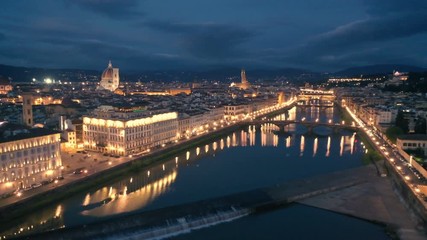 Aerial night view of Florence, Tuscany, Italy. Flying over the Arno river, view to the Florence Cathedral, formally the Cattedrale di Santa Maria del Fiore, Palazzo Vecchio and Ponte Vecchio 