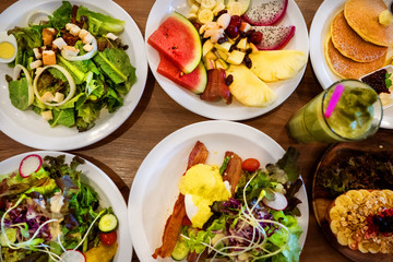 plates with dishes. stand on steel, salads, desserts and fruits