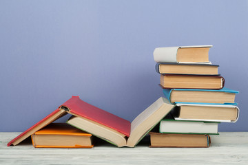 Open book, hardback colorful books on wooden table. Back to school. Copy space for text. Education business concept.