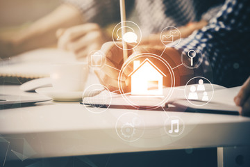 Abstract holographic city on man's hand writing notes background. Double exposure.