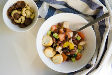Summer salad with beans, tomatoes, cucumber, pepper and chicken dressed with olive oil