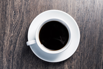 Cup of natural coffee on wooden table