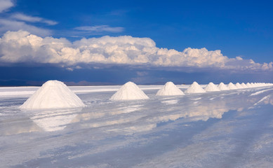 Colorful row of white salt pyramids in the salt desert, Salt flats of Uyuni, Bolivia, near border with Chile, Potosi, South America