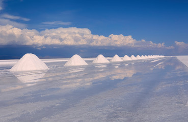 Colorful row of white salt pyramids in the salt desert, Salar de Uyuni, Bolivia, near border with Chile, South America