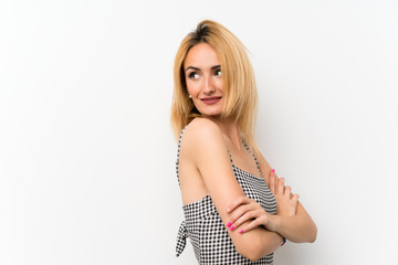 Fototapeta premium Young blonde woman over isolated white with arms crossed and happy