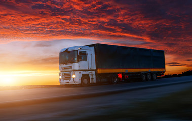 big White Truck on the Road in a Rural Landscape at Sunset.