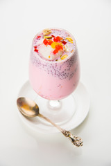 Falooda / Faluda is a popular Indian dessert - Strawberry and Mango flavoured which has Ice cream, noodles, sweet basil seeds and nuts, selective focus