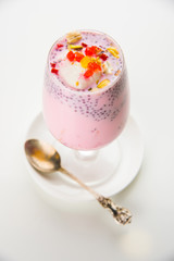 Falooda / Faluda is a popular Indian dessert - Strawberry and Mango flavoured which has Ice cream, noodles, sweet basil seeds and nuts, selective focus