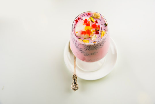 Falooda / Faluda is a popular Indian dessert - Strawberry and Mango flavoured which has Ice cream, noodles, sweet basil seeds and nuts, selective focus