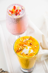 Falooda / Faluda is a popular Indian dessert - Strawberry and Mango flavoured which has Ice cream, noodles, sweet basil seeds and nuts, selective focus