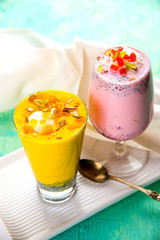 Falooda / Faluda is a popular Indian dessert - Strawberry and Mango flavoured which has Ice cream, noodles, sweet basil seeds and nuts, selective focus