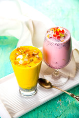 Falooda / Faluda is a popular Indian dessert - Strawberry and Mango flavoured which has Ice cream, noodles, sweet basil seeds and nuts, selective focus