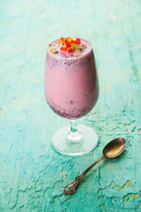 Falooda / Faluda is a popular Indian dessert - Strawberry and Mango flavoured which has Ice cream, noodles, sweet basil seeds and nuts, selective focus