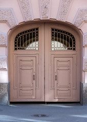 old closed wooden gate in the arch of a European building