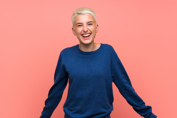 Teenager girl with white short hair over pink wall smiling