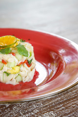 Vegetarian mushroom ceviche served on a red ceramic plate, fine casual dining concept