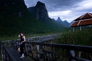 Lonely Black Dress Lady in the park with mountain and walkway