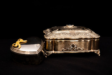 Silver vintage square jewelry box and metal heart-shaped box, black background