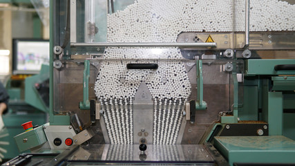 Obraz na płótnie Canvas Cigarettes production line in a tobacco factory