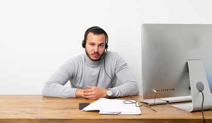Fototapeta premium Telemarketer Colombian man with sad and depressed expression