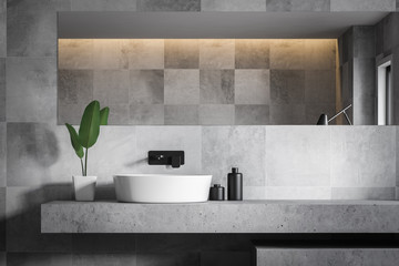 Close up of gray tile bathroom with sink - obrazy, fototapety, plakaty