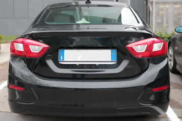 Empty License plate on the back of a black car