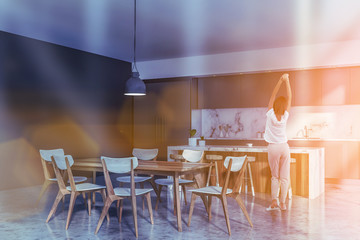 Woman in gray and marble kitchen corner
