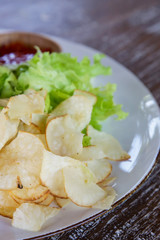 Chips and green salad on the plate