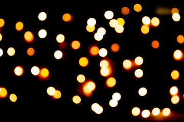 Unfocused abstract gold bokeh on black background. defocused and blurred many round light
