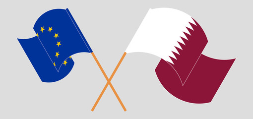 Crossed and waving flags of the EU and Qatar