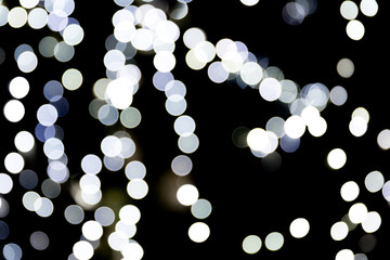 Abstract glitter sparkle bokeh defocused on black background. many round light on background