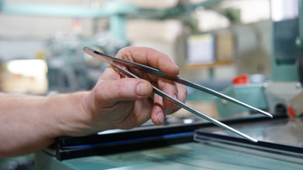 The hand with a tweezers in laboratory