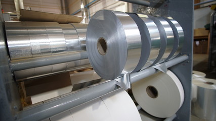 Shiny foil rolls for cigarettes packing in a tobacco factory