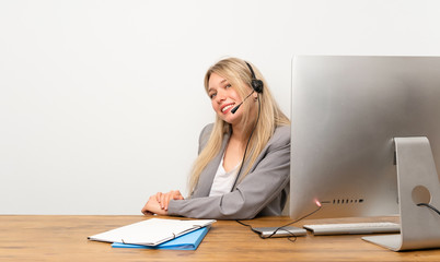 Young woman working with headset laughing