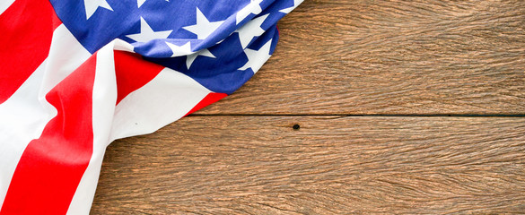 close up top view of usa flag on brown wood background for culture concept