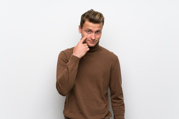 Blonde man over isolated white wall looking to the front