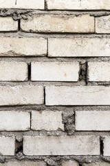 An old wall of white bricks close up